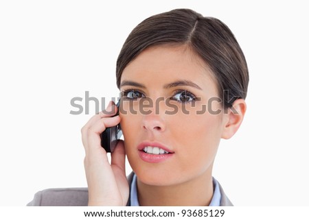 Close up of female entrepreneur talking on her cellphone against a white background