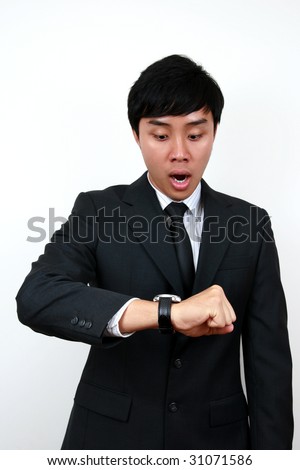 Young Asian Business man looking at his watch.