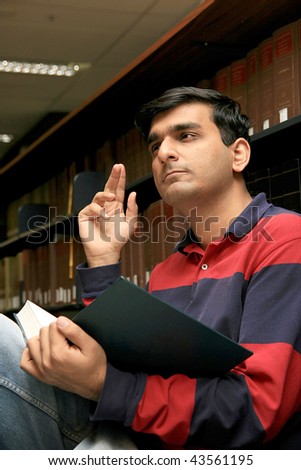 Indian student studying in a  library.