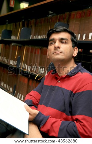 Indian student studying in a  library.