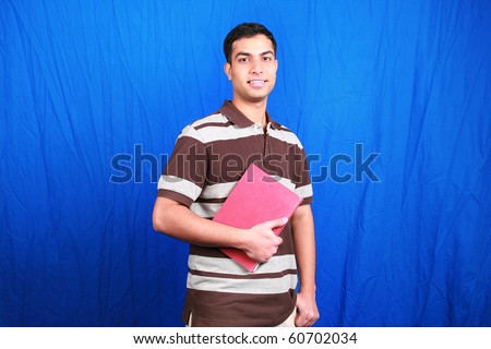 Young Indian student with books in hand.