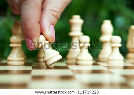 woman playing chess and hold pawn background