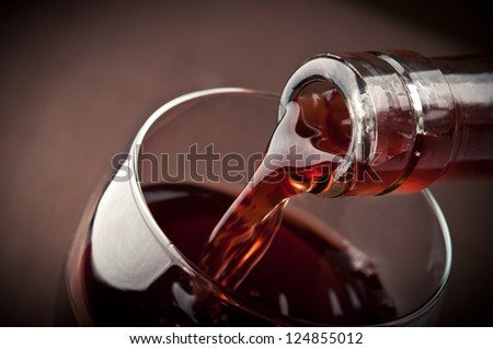 Pouring Red Wine On Background