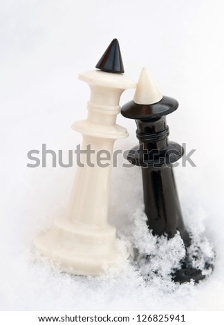 winter chess pieces on snow