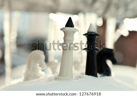 winter chess pieces on snow