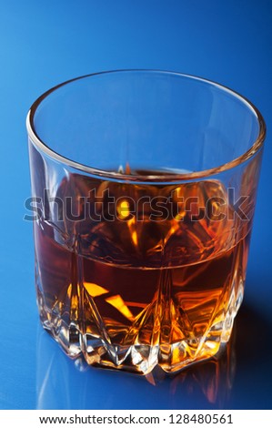 glass of whiskey on background