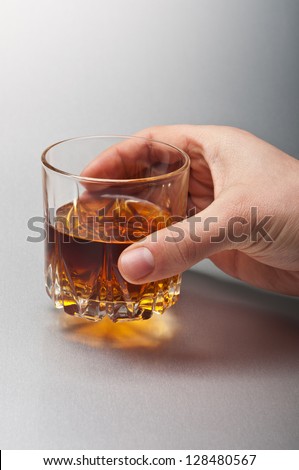 man holding glass of whiskey