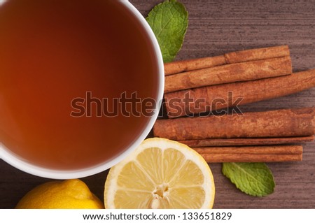 Hot cup of tea and fresh lemons. Top view.