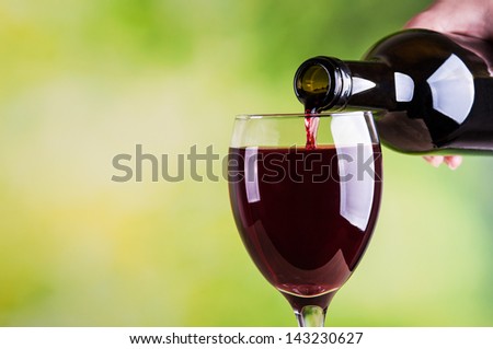 Woman pouring red wine into glass