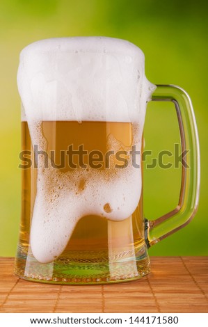 Beer mug with fresh beer. On natural background