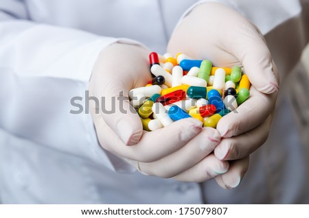 close up of doctor hand with pills