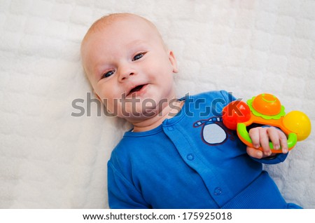 adorable smiling baby boy on soft cover