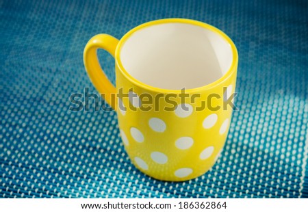 empty yellow mug on kitchen table