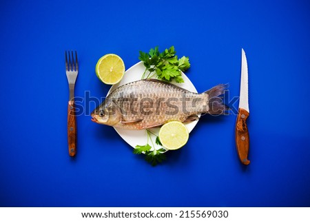 fresh fish carp on white plate