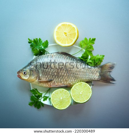 fresh fish crucian on white plate. fancy dinner