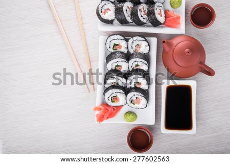 Sushi and roll with cream cheese and waabi on kitchen table