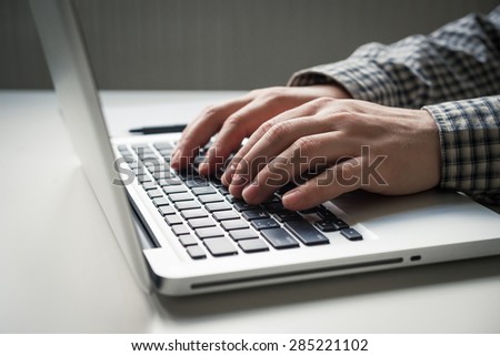 Closeup of man hands on laptop