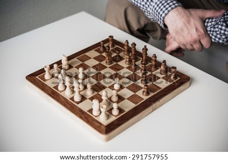 Man thinks about the next move in a chess game