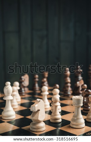 chess pieces on black wood background