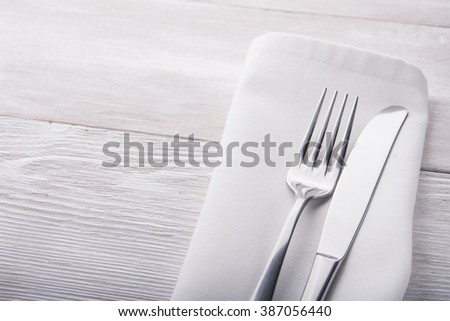 metal fork and knife on wooden table