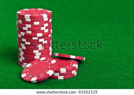 red poker chips on a green table background