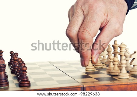 old man playing chess isolated on a white background