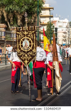 MALAGA, SPAIN - JULY 16: Unidentified local worshippers carry a religious banner during the \'Virgen del Carmen\' procession on July 16, 2012 in Malaga, Spain.
