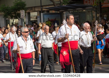 MALAGA, SPAIN - JULY 16: Unidentified local worshippers carry a brotherhood staff during the \'Virgen del Carmen\' procession on July 16, 2012 in Malaga, Spain.