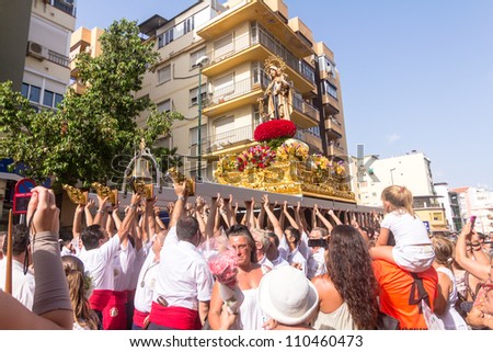 MALAGA, SPAIN - JULY 16: Unidentified local worshippers carry a religious image during the \'Virgen del Carmen\' procession on July 16, 2012 in Malaga, Spain.