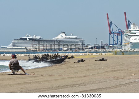 MALAGA, SPAIN - MAY 28: Troops land at Malagueta Beach while being broadcasted on national TV during the Spanish Armed Forces Day on May 28, 2011 in Malaga, Spain.
