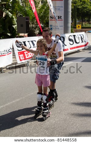MALAGA, SPAIN - JUNE 19: Unidentified participants cross the finish line at the 6th Skate Day race on June 19, 2011 in Malaga, Spain
