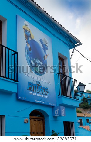 JUZCAR, SPAIN - CIRCA JUNE 2011: Smurfs movie poster on a house of the village circa June 2011 in Malaga, Spain. Sony chose Juzcar to be painted blue for the world premiere of the new Smurfs movie