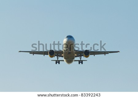 Airplane landing with a blue sky