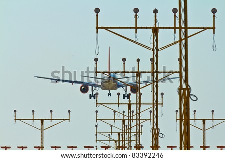 An airplane landing viewed through landing lights