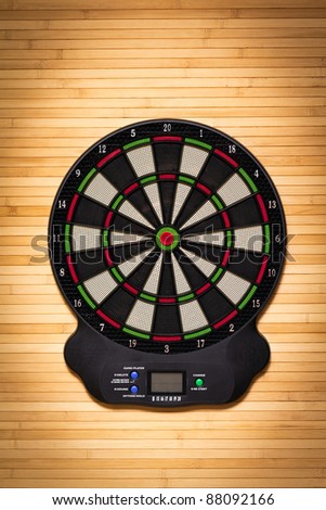 Electronic dart board on a wooden wall