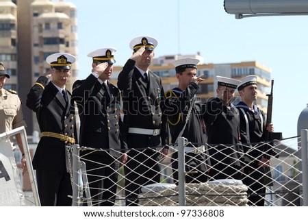 MALAGA, SPAIN - MARCH 4:  Crew of turkish navy minesweeper TCG Sokullu Mehmet Pasa salute local visitors while docked on March 4, 2012 in Malaga, Spain.
