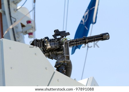 A machine gun on the side of a British Navy warship