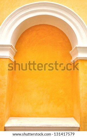 Arch molding decorates on the yellow concrete wall