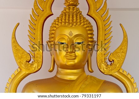 golden buddha statue face close up