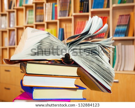 Open book lying on a stack of books