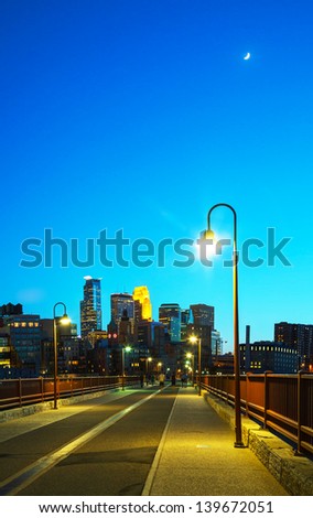 Downtown Minneapolis, Minnesota at night time as seen from the famous Stone Arch bridge