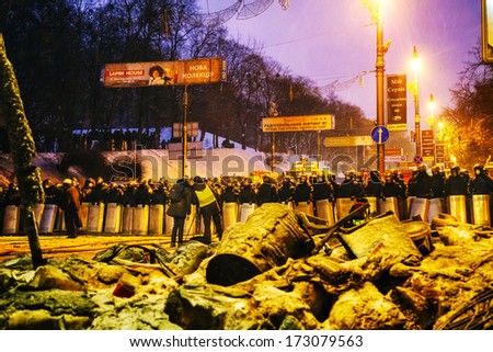KIEV, UKRAINE - JANUARY 23: BBC reporters in front of the riot police at Hrushevskogo street on January 23, 2014 in Kiev, Ukraine. The protests turned into violent clashes during last week.