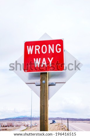 Wrong way sign at a highway in mountains