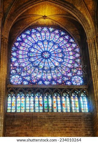 PARIS - OCTOBER 11: The North Rose stained-glass window of Notre Dame on October 11, 2014 in Paris, France. Its main theme is the Old Testament, but the central medallion depicts the Virgin and Child.