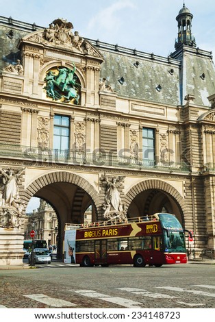 PARIS - OCTOBER 9: Touristic bus entering the Louvre on October 9, 2014 in Paris, France. The Louvre Museum is one of the world\'s largest museums, a historic monument and a central landmark of Paris.