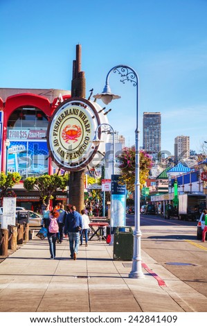 SAN FRANCISCO - APRIL 24: Famous Fisherman\'s Wharf sign with tourists on April 24, 2014 in San Francisco, California. It\'s one of the busiest and well known tourist attractions in the western US