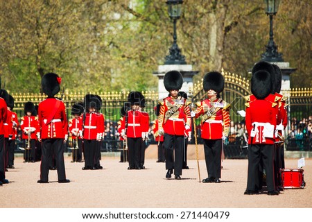 LONDON - APRIL 13: Queen\'s Guards at the Buckingham palace on April 13, 2015 in London, UK. It\'s the name given to the contingent of infantry guarding Buckingham Palace and St James\'s Palace.
