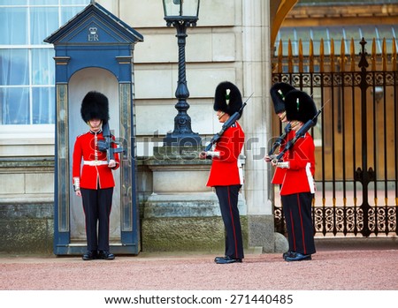 LONDON - APRIL 13: Queen\'s Guards at the Buckingham palace on April 13, 2015 in London, UK. It\'s the name given to the contingent of infantry guarding Buckingham Palace and St James\'s Palace.