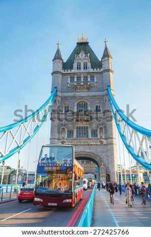LONDON - APRIL 14: Tower bridge with touristic bus on April 14, 2015 in London, UK. It (built 1886-1894) is a combined bascule and suspension bridge in London, England which crosses the River Thames.