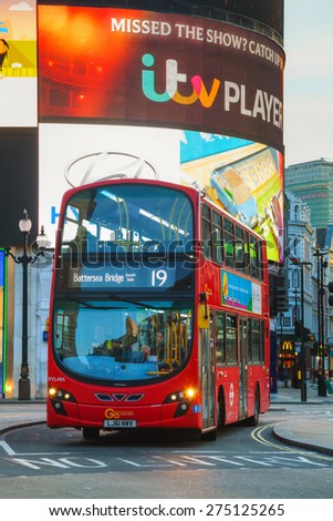 LONDON - APRIL 12: Piccadilly Circus junction with the red double decker bus on April 12, 2015 in London, UK. It\'s a road junction and public space of London\'s West End in the City of Westminster.